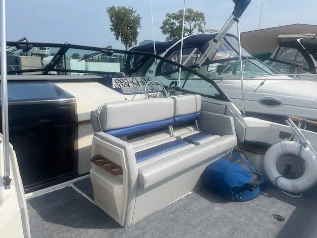 Slide: The Image of 1988 Regal 277 Commodore XL boat interior with seating, life preserver, and dashboard controls. - 9
