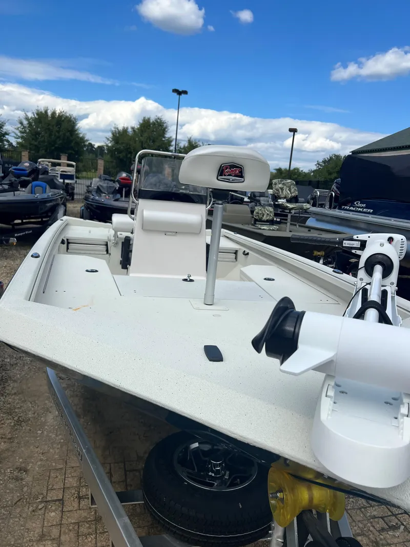 Slide: The Image of 2024 Ranger RB190 boat with trolling motor, parked outdoors under a blue sky. - 4