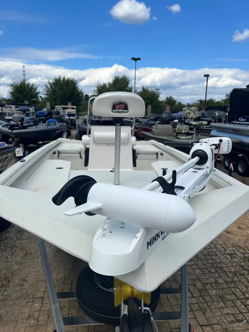 Slide: The Image of 2024 Ranger RB190 boat with Minn Kota trolling motor, parked outdoors under a blue sky. - 5