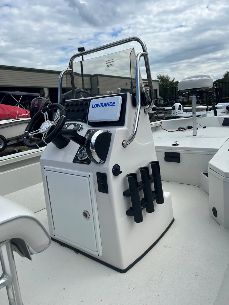Slide: The Image of 2024 Ranger RB190 boat console with Lowrance electronics, steering wheel, and rod holders. - 9