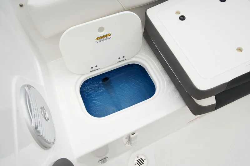 Slide: The Image of 2024 Tahoe 200 S boat interior with blue and white seating and steering wheel. - 23