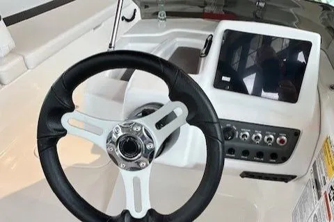 Slide: The Image of 2024 Tahoe T18 boat dashboard with steering wheel and control panel. - 3