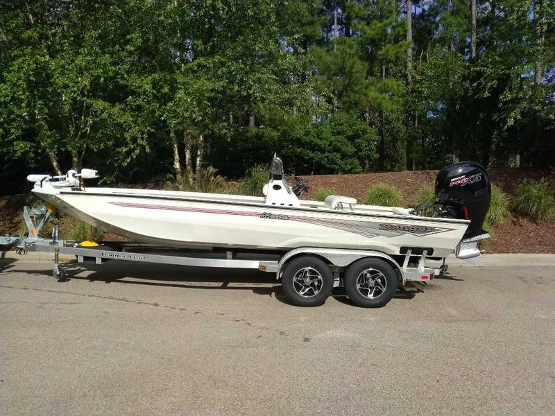 Slide: The Image of 2024 Ranger RB200 boat on trailer, parked outdoors, surrounded by trees. - 3