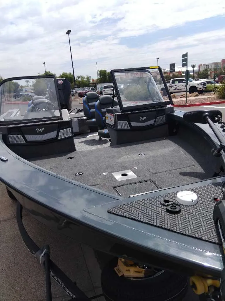 Slide: The Image of 2024 Ranger VX1988 WT boat, sleek design, parked outdoors. - 3