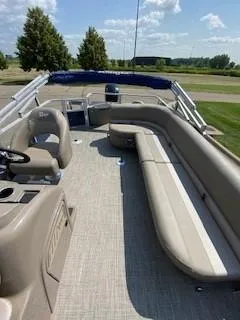 Slide: The Image of 2024 Ranger Reata 200F pontoon boat with spacious seating and modern design. - 11
