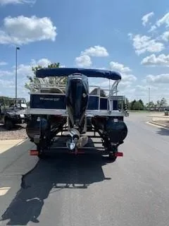 Slide: The Image of 2024 Ranger Reata 200F boat on trailer, sunny day, blue sky. - 4