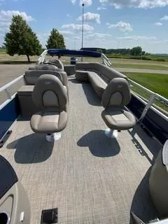 Slide: The Image of 2024 Ranger Reata 200F pontoon boat with spacious seating and modern design. - 5