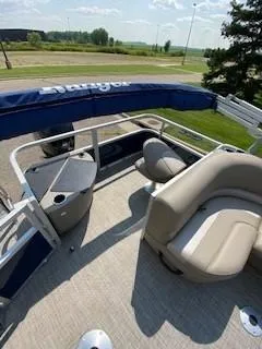 Slide: The Image of 2024 Ranger Reata 200F pontoon boat interior with seating and railing. - 8