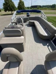 Slide: The Image of 2024 Ranger Reata 200F pontoon boat interior with beige seating and open deck. - 5