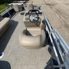 Slide: The Image of 2024 Ranger Reata 200F boat interior with steering console and seating. - 6