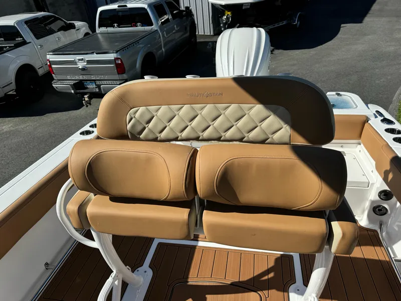 Slide: The Image of 2025 NauticStar 24 OSL boat seating with tan upholstery and diamond stitching. - 12