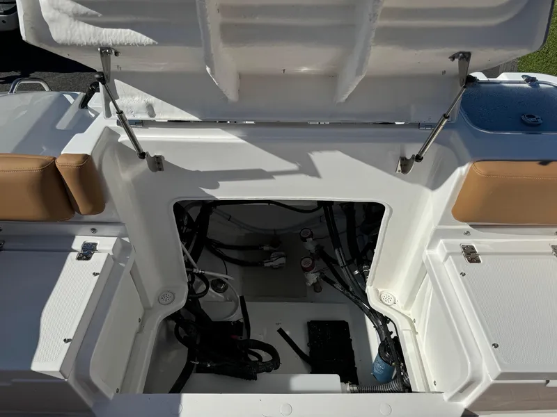Slide: The Image of Open storage compartment of 2025 NauticStar 24 OSL boat, showcasing interior details. - 18