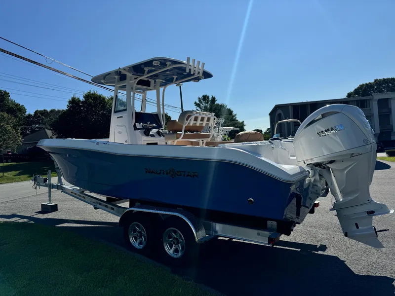 Slide: The Image of 2025 NauticStar 24 OSL boat on trailer, sunny day, side view. - 3