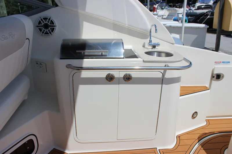 Slide: The Image of 2012 Sea Ray 280 Sundancer boat kitchenette with sink and grill on deck. - 10