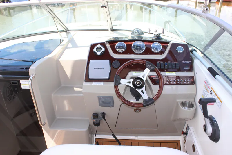 Slide: The Image of Cockpit of 2012 Sea Ray 280 Sundancer with steering wheel and navigation instruments. - 14