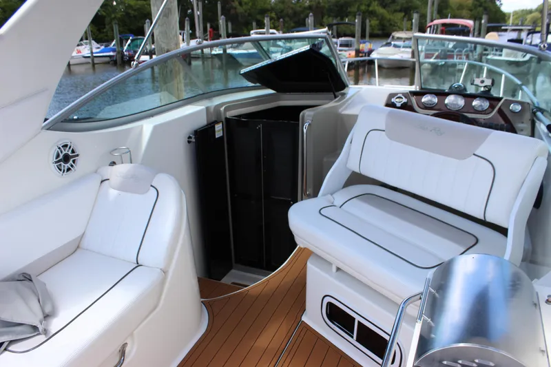 Slide: The Image of 2012 Sea Ray 280 Sundancer interior with white seating and wood flooring. - 20