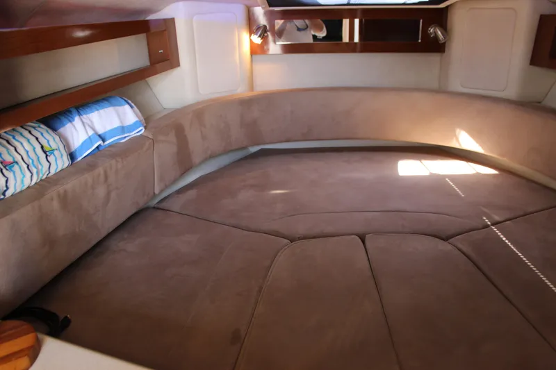 Slide: The Image of Cozy interior cabin of 2012 Sea Ray 280 Sundancer with plush seating and ambient lighting. - 26