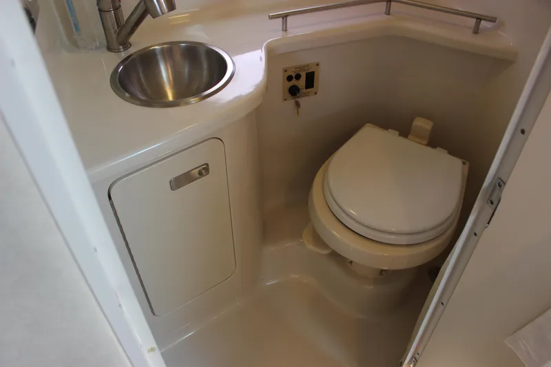 Slide: The Image of Compact bathroom in 2012 Sea Ray 280 Sundancer with sink and toilet. - 27
