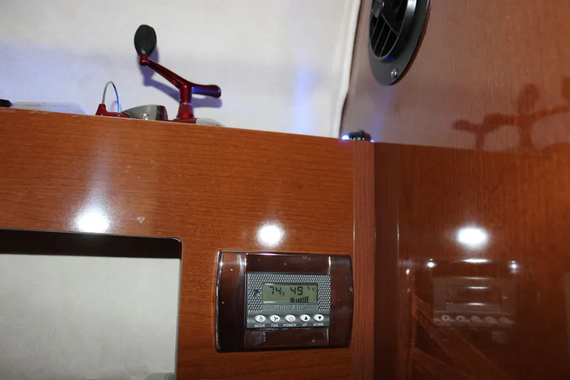 Slide: The Image of Interior of 2012 Sea Ray 280 Sundancer with digital control panel and wooden finish. - 28