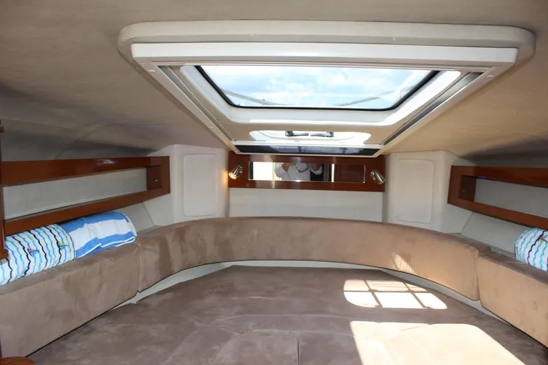 Slide: The Image of 2012 Sea Ray 280 Sundancer cabin interior with skylight and seating area. - 31