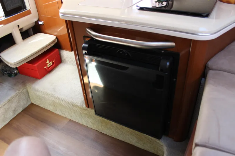 Slide: The Image of Interior of 2012 Sea Ray 280 Sundancer with compact fridge and seating area. - 35