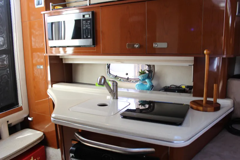 Slide: The Image of Interior of 2012 Sea Ray 280 Sundancer yacht with modern kitchenette and microwave. - 36