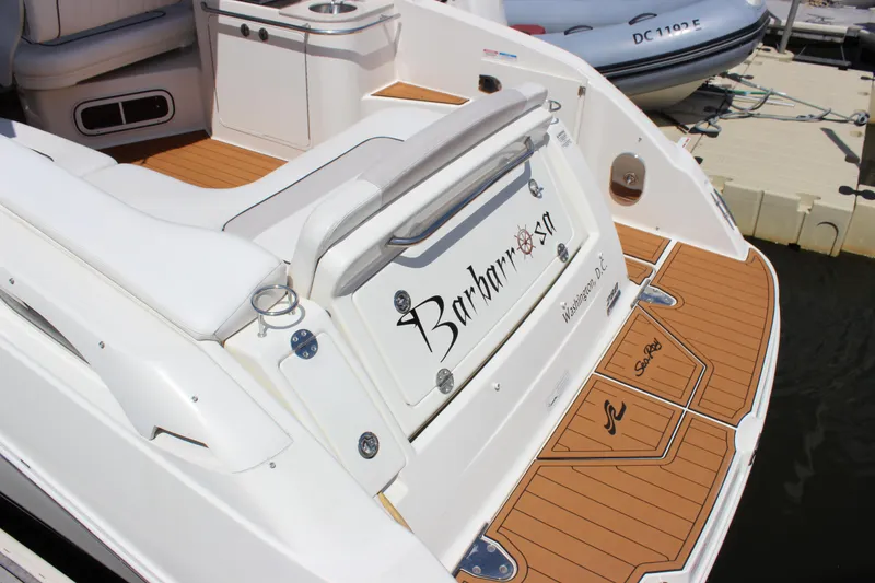 Slide: The Image of 2012 Sea Ray 280 Sundancer boat with teak deck, docked at marina. - 4