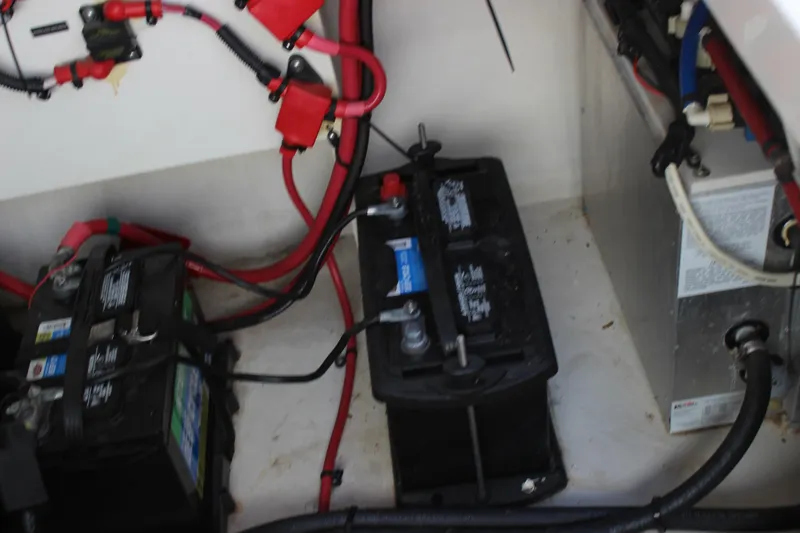 Slide: The Image of Battery compartment of a 2012 Sea Ray 280 Sundancer with wiring and connections. - 40