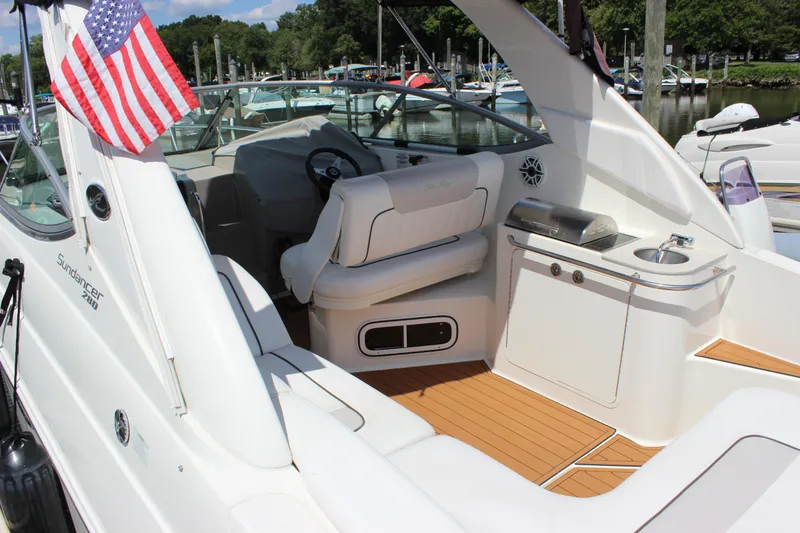 Slide: The Image of 2012 Sea Ray 280 Sundancer boat interior with American flag, docked at marina. - 5