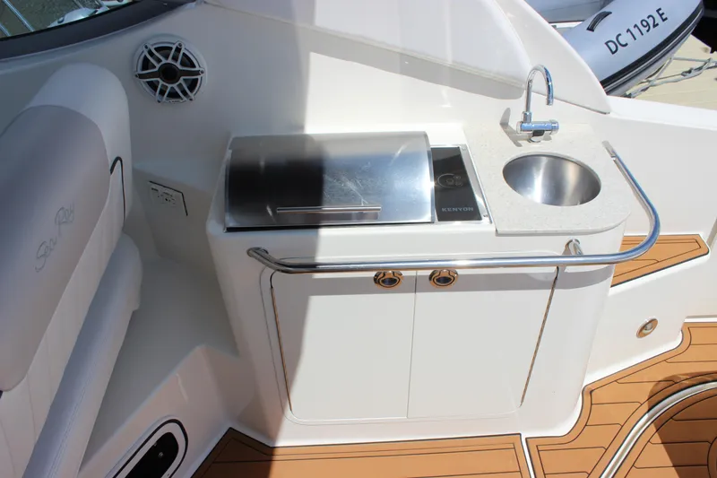 Slide: The Image of 2012 Sea Ray 280 Sundancer boat kitchenette with sink and grill on deck. - 7