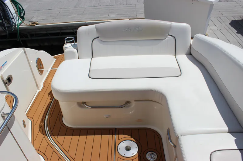 Slide: The Image of 2012 Sea Ray 280 Sundancer boat interior with white seating and teak flooring. - 8
