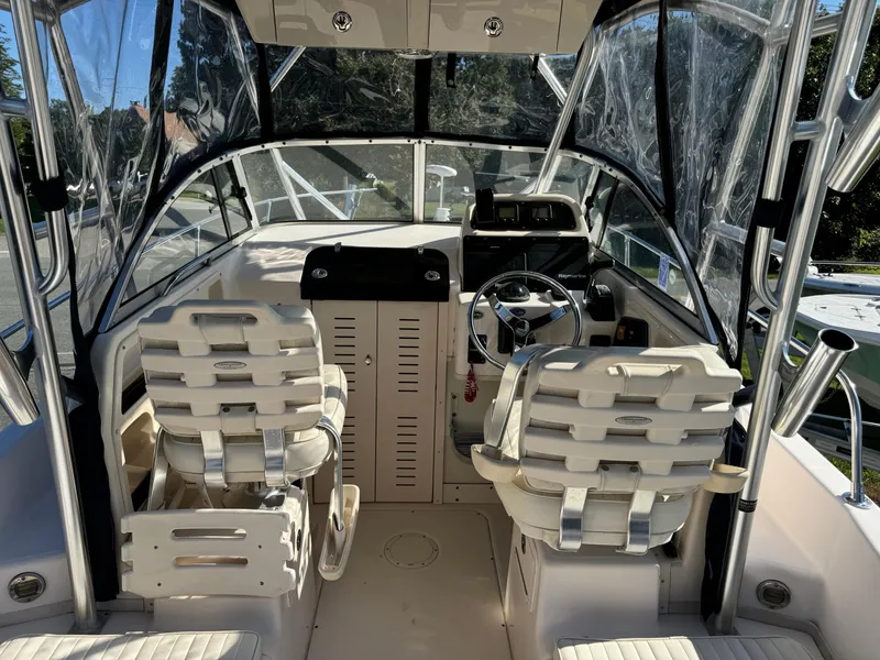 Slide: The Image of 2009 Grady-White 228 Seafarer boat interior with dual captain seats and steering console. - 11