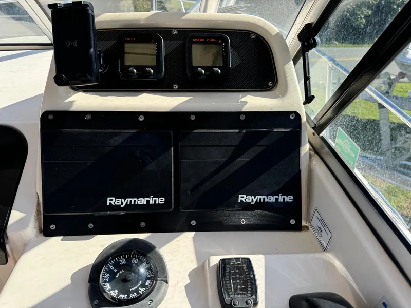 Slide: The Image of Grady-White 228 Seafarer 2009 boat dashboard with Raymarine electronics and compass. - 13