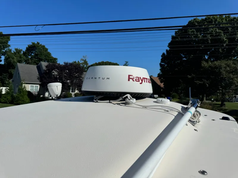 Slide: The Image of 2009 Grady-White 228 Seafarer boat with Raymarine radar, parked in a residential area. - 15