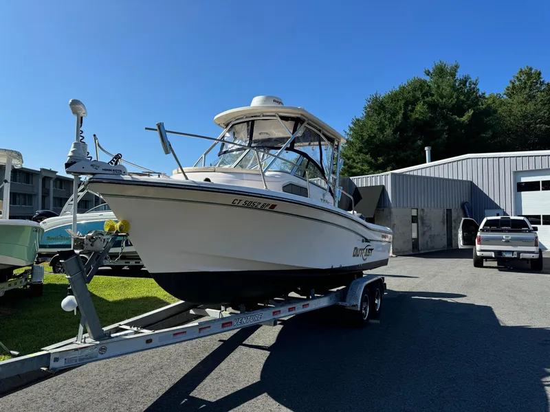 Slide: The Image of 2009 Grady-White 228 Seafarer boat on trailer, parked outdoors near a building. - 6