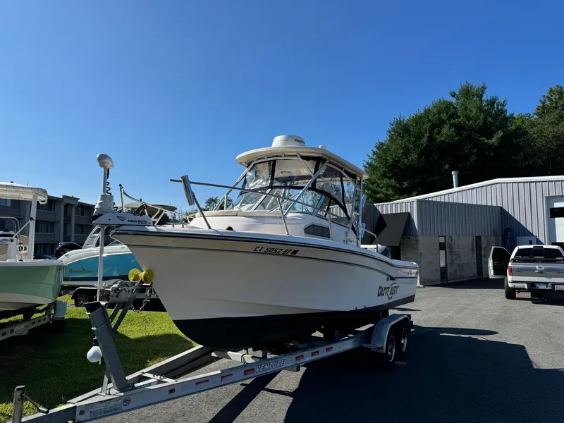 Slide: The Image of 2009 Grady-White 228 Seafarer boat on trailer, parked outdoors under clear blue sky. - 7