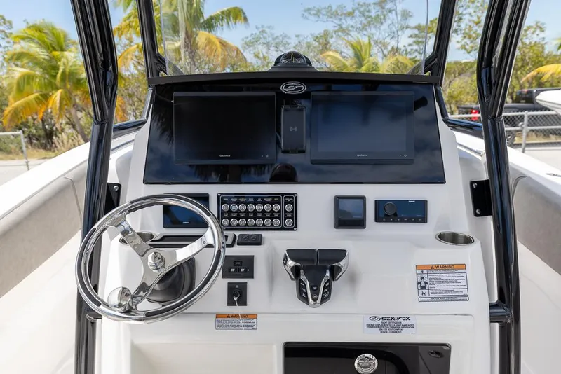 Slide: The Image of 2024 Sea Fox 288 Commander boat dashboard with steering wheel and electronic displays. - 10