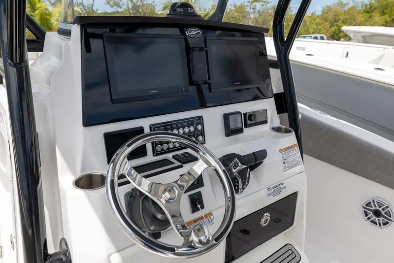 Slide: The Image of 2024 Sea Fox 288 Commander boat dashboard with dual screens and steering wheel. - 13
