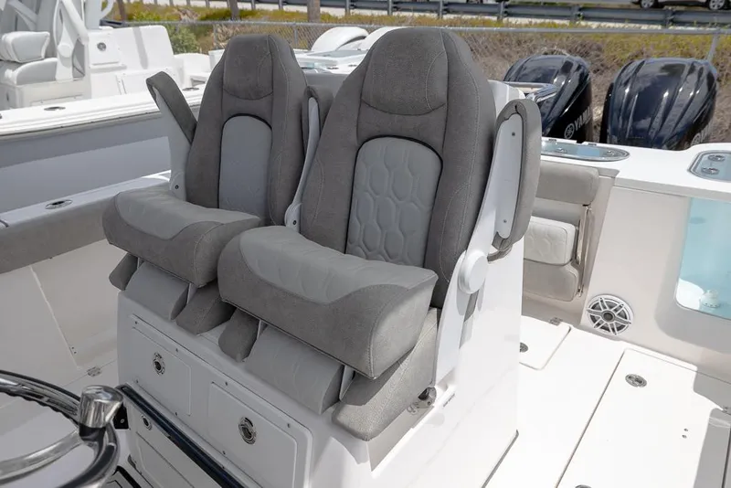 Slide: The Image of 2024 Sea Fox 288 Commander boat with plush gray seating and dual outboard motors. - 14