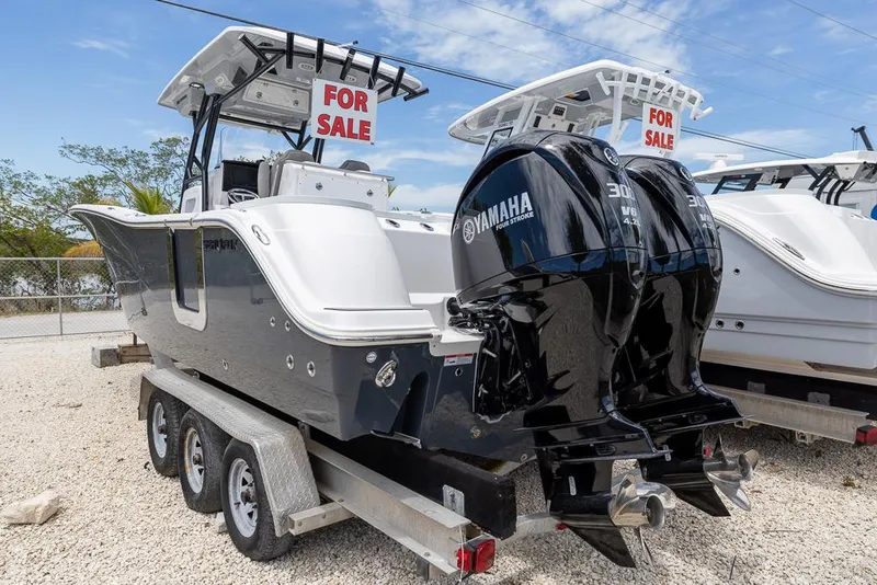 Slide: The Image of 2024 Sea Fox 288 Commander boat with twin Yamaha engines for sale on trailer. - 2
