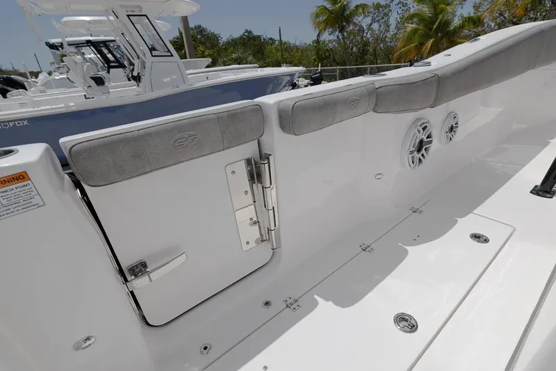 Slide: The Image of 2024 Sea Fox 288 Commander boat interior with cushioned seating and speaker system. - 20