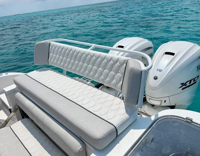 Slide: The Image of 2024 Sea Fox 328 Commander boat with Yamaha engines on turquoise water. - 15