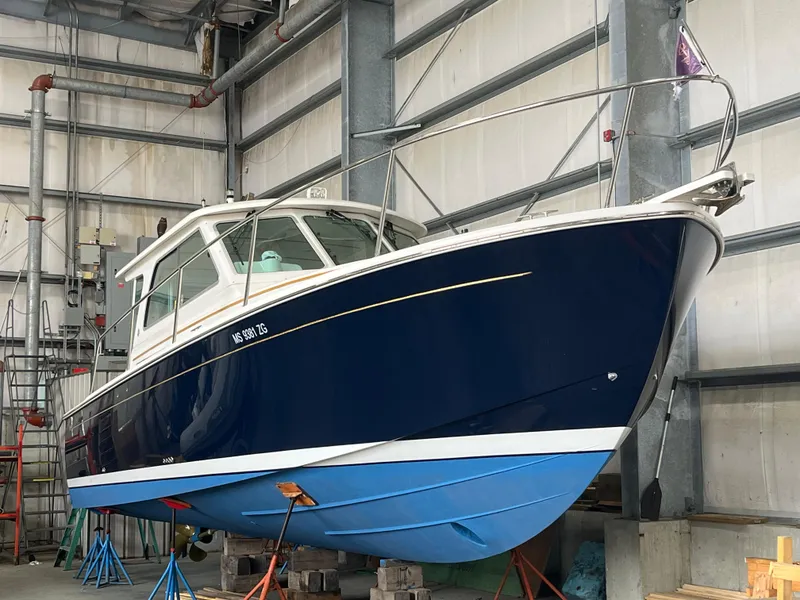 Slide: The Image of 2014 Back Cove 34 Hard Top/Hard Back boat in indoor storage on stands. - 12