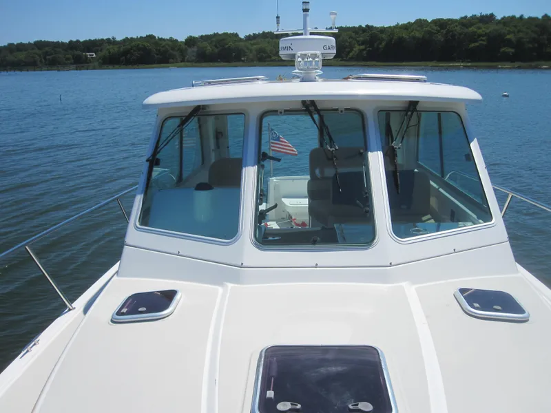 Slide: The Image of 2014 Back Cove 34 Hard Top boat on calm water, front view. - 16
