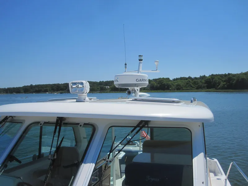 Slide: The Image of 2014 Back Cove 34 Hard Top boat on water, featuring radar and antenna. - 18