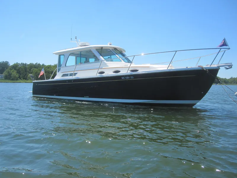 Slide: The Image of 2014 Back Cove 34 Hard Top boat on calm water. - 2