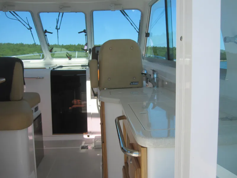 Slide: The Image of Interior of 2014 Back Cove 34 Hard Top/Hard Back boat, featuring helm and seating area. - 20