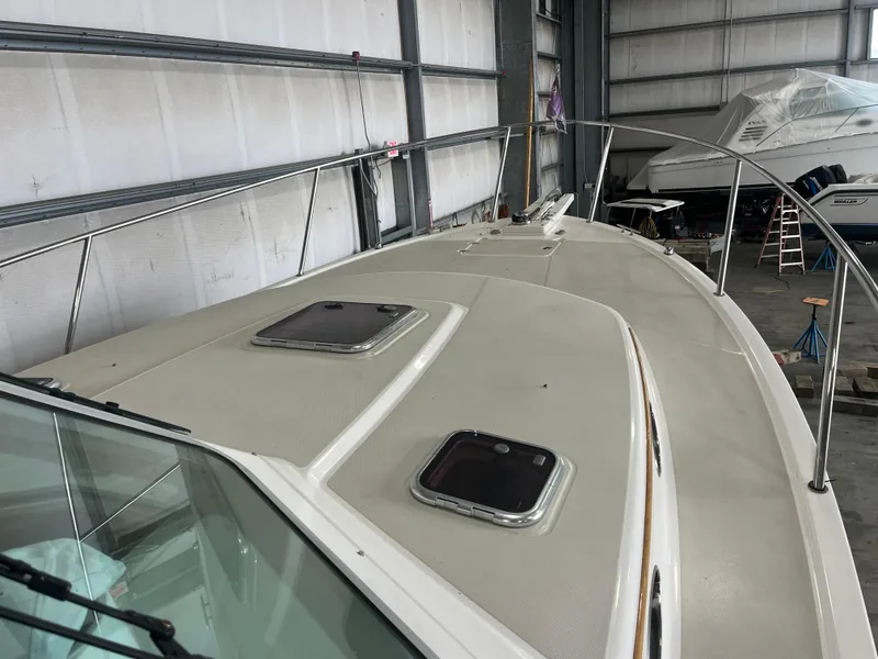 Slide: The Image of 2014 Back Cove 34 Hard Top boat in storage, showing deck and hatches. - 22