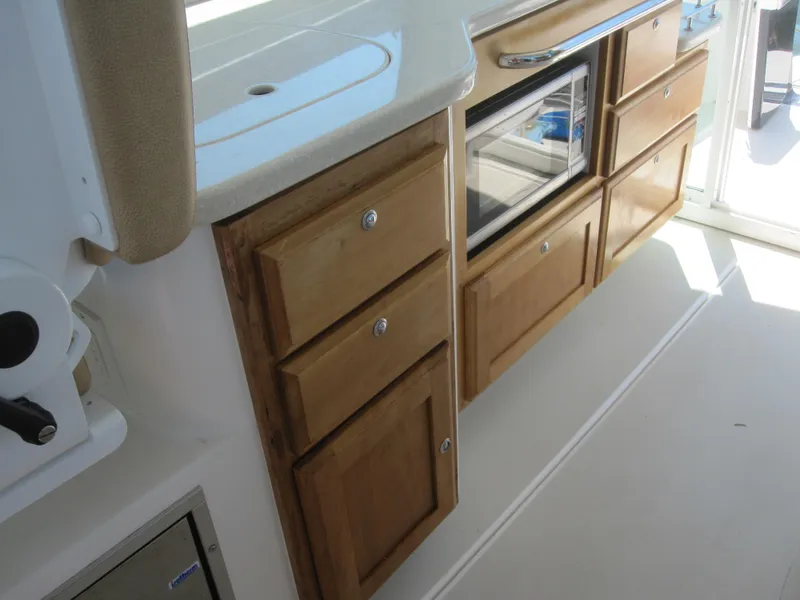 Slide: The Image of 2014 Back Cove 34 interior with wooden cabinets and built-in microwave. - 28