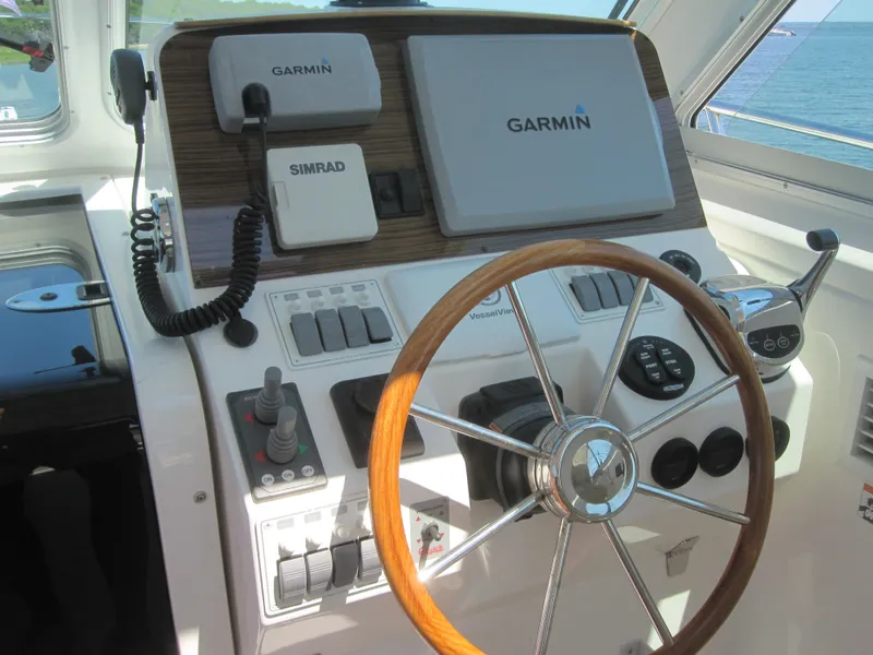 Slide: The Image of 2014 Back Cove 34 helm with Garmin and Simrad navigation systems. - 30